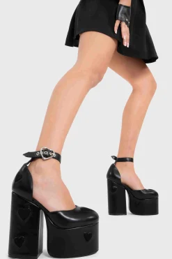 Lamoda Platform>Translate Love Platform Heels In Black Faux Leather. Elevate Your Style With Silver Heart Details, Adjustable Strap, And Eco-Friendly, Cruelty-Free Materials. 100% Vegan